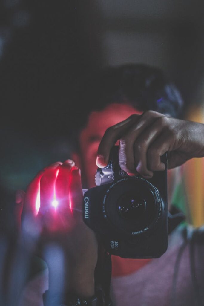 Person Holding Black Canon Dslr Camera